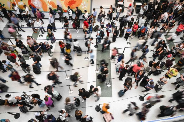 Travelers wait in long security lines at George Bush Intercontinental Airport in Houston, Texas on March 23, 2026. (Photo by RONALDO SCHEMIDT / AFP)