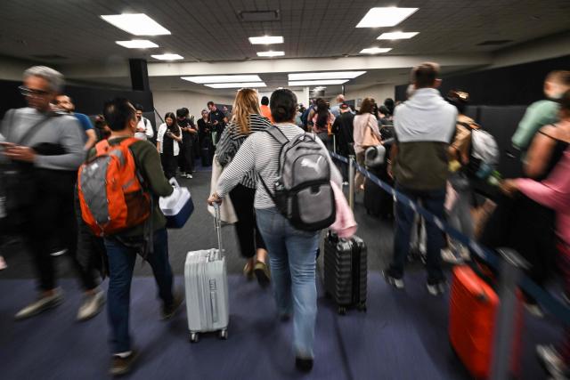Travelers wait in long security lines at George Bush Intercontinental Airport in Houston, Texas on March 23, 2026. (Photo by RONALDO SCHEMIDT / AFP)