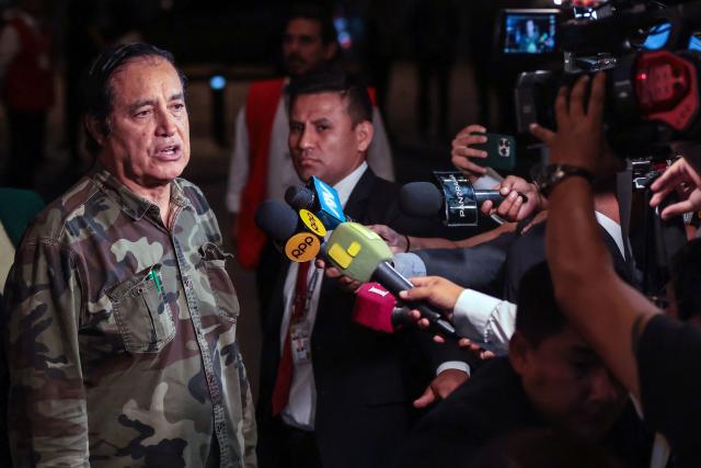 Peru's presidential candidate Alex Gonzales, from the Democrata Verde party, speaks to the press as he arrives at the Lima Convention Center ahead of the first round of debates on tackling crime and corruption in Lima on March 23, 2026, ahead of the April 12 general election. (Photo by Connie FRANCE / AFP)