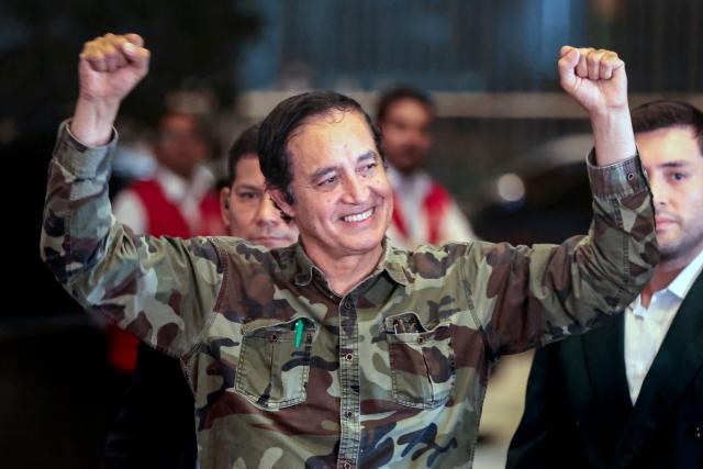 Peru's presidential candidate Alex Gonzales, from the Democrata Verde party, gestures as he arrives at the Lima Convention Center ahead of the first round of debates on tackling crime and corruption in Lima on March 23, 2026, ahead of the April 12 general election. (Photo by Connie FRANCE / AFP)