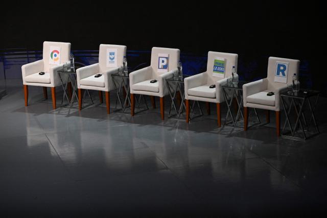 The chairs of candidates in the television studio are seen ahead of the first round of debates on tackling crime and corruption at the Lima Convention Center in Lima on March 23, 2026, ahead of the April 12 general election. (Photo by ERNESTO BENAVIDES / AFP)