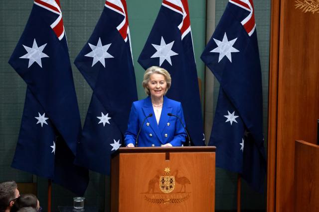 European Commission President Ursula von der Leyen addresses members and senators during a joint sitting of the House of Representatives at Parliament House in Canberra on March 24, 2026. (Photo by DAVID GRAY / AFP)