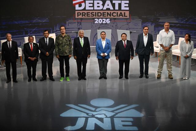 (L to R) Peru's presidential candidates: Rafael Lopez Aliaga, for the Renovacion Popular party; Cesar Acuna, for the Alianza para el Progreso party; Jose Williams, for the Avanza Pais party; Alex Gonzales, for the Democrata Verde party; Fernando Olivera, for the Frente de la Esperanza party; Carlos Alvarez, for the Pais Para Todos party; Jose Luna Galvez, for the Podemos Peru party; Yonhy Lescano, for the Cooperacion Popular party; Wolfgang Grozo, for the Integridad Democratica party; and Marisol Perez Tello, for the Primero la Gente party, stand during the first round of debates on tackling crime and corruption at the Lima Convention Center in Lima on March 23, 2026, ahead of the April 12 general election. (Photo by ERNESTO BENAVIDES / AFP)