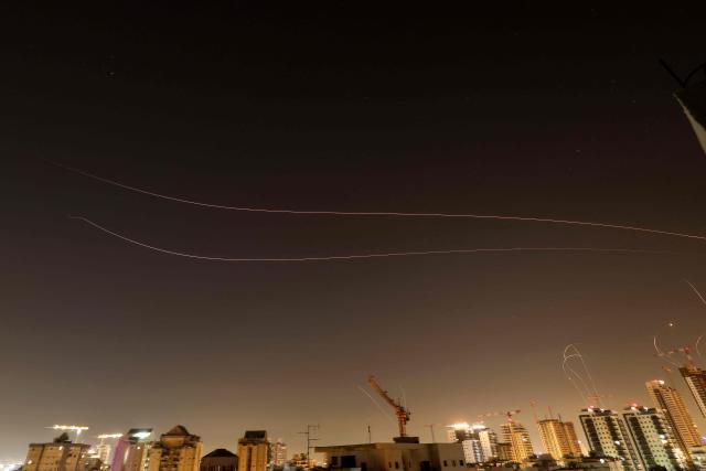 Rocket trails are seen in the sky above the Israeli coastal city of Netanya amid a fresh barrage of Iranian missile attacks on March 24, 2026. Iran launched another round of missiles towards Israel early on March 24, state television announced. (Photo by JACK GUEZ / AFP) / 