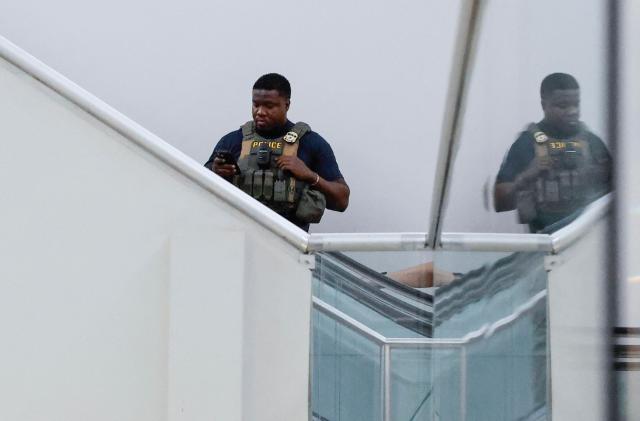 A federal law enforcement agent,is seen inside Newark Liberty International Airport in Newark, New Jersey, on March 23, 2026. Immigration agents will be deployed in US airports beginning Monday, aiming to alleviate soaring congestion at security screenings amid a weeks-long budget standoff over President Donald Trump's mass deportation drive, officials said. (Photo by kena betancur / AFP)