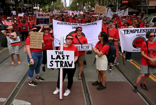 Teachers march through Melbourne's city centre to protest over pay and conditions on March 24, 2026. Tens of thousands of public school teachers went on strike for the first time in thirteen years following a pay dispute with the state government, closing or disrupting some 500 state schools. (Photo by William WEST / AFP)
