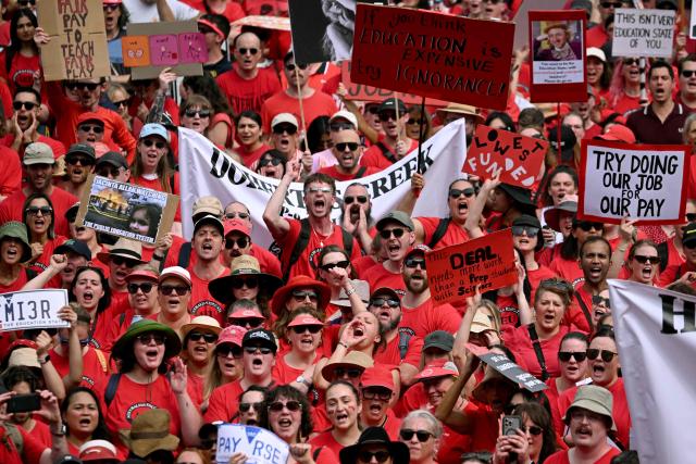 Teachers march through Melbourne's city centre to protest over pay and conditions on March 24, 2026. Tens of thousands of public school teachers went on strike for the first time in thirteen years following a pay dispute with the state government, closing or disrupting some 500 state schools. (Photo by William WEST / AFP)