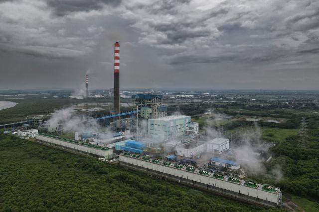 (FILES) This aerial picture taken on January 28, 2026 shows the Cirebon-1 coal power plant in Cirebon, West Java. Asian countries are ramping up use of polluting coal to tackle energy shortages and price spikes linked to the Iran war, but the crisis could have an environmental silver lining. (Photo by BAY ISMOYO / AFP)