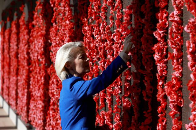 European Commission President Ursula von der Leyen places a poppy at the Roll of Honour during her visit to the Australian War Memorial in Canberra on March 24, 2026. (Photo by DAVID GRAY / AFP)