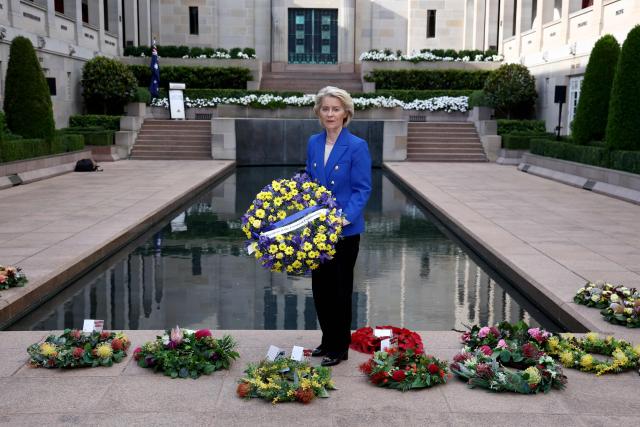 European Commission President Ursula von der Leyen holds a wreath as she visits the Australian War Memorial in Canberra on March 24, 2026. (Photo by David GRAY / AFP)
