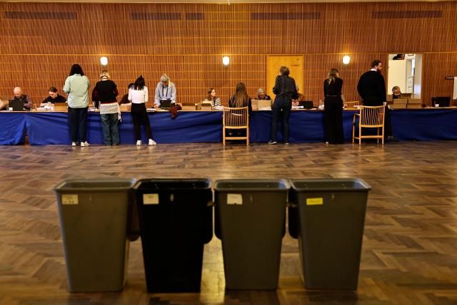 Citizens vote at a polling station during the parliamentary election at Aarhus City Hall in Aarhus on March 24, 2026. (Photo by Mikkel Berg Pedersen / Ritzau Scanpix / AFP) / Denmark OUT