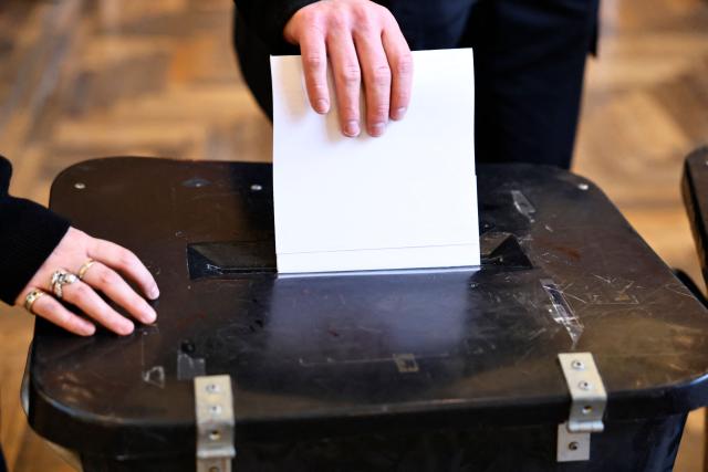 A citizen casts their ballot for the parliamentary election at a polling station at Aarhus City Hall in Aarhus on March 24, 2026. (Photo by Mikkel Berg Pedersen / Ritzau Scanpix / AFP) / Denmark OUT
