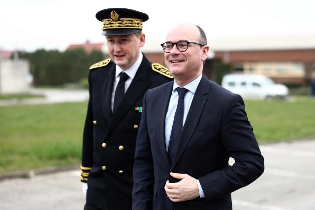 French Minister Delegate for Industry Sebastien Martin (R) is welcomed by Prefect of the Pas-de-Calais department François-Xavier Lauch at the start of his visit at  the ARC International glassware plant amid the company's receivership proceedings, in Arques, northern France, on March 24, 2026. (Photo by Sameer AL-DOUMY / AFP)
