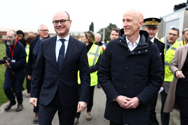 French Minister Delegate for Industry Sebastien Martin (L) speaks with incoming ARC International CEO Timothee Durand (R) at the start of his visit to the ARC International glassware plant amid the company's receivership proceedings, in Arques, northern France, on March 24, 2026. Timothée Durand is the incoming CEO of ARC International, whose takeover was validated by the Lille Commercial Court, with his mandate starting April 1, 2026. (Photo by Sameer AL-DOUMY / AFP)