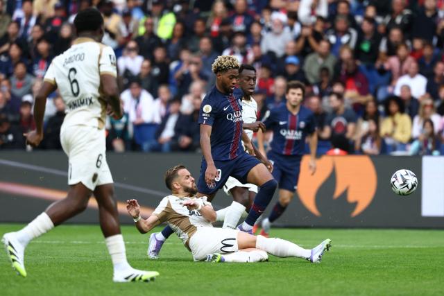 (FILES) Paris Saint-Germain's French forward #49 Ibrahim Mbaye (R) fights for the ball with Lens' French defender #24 Jonathan Gradit (C) during the French L1 football match between Paris Saint-Germain (PSG) and RC Lens at the Parc des Princes stadium in Paris, on September 14, 2025. RC Lens' management said it opposes postponing its match against Paris Saint-Germain scheduled in three weeks, citing its commitment to "fairness, clear rules and respect for all parties" on the evening of March 23, 2026. (Photo by FRANCK FIFE / AFP)