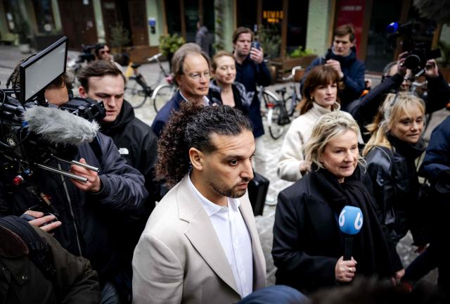 Dutch former coach on talent show "The Voice of Holland" Ali B. (C) arrives for a substantive hearing as part of his appeal trial at the Amsterdam Court of Appeal in Amsterdam on March 24, 2026. The 43-years-old rapper was sentenced to two years in prison for rape on July 12, 2024. (Photo by Robin van Lonkhuijsen / ANP / AFP) / Netherlands OUT