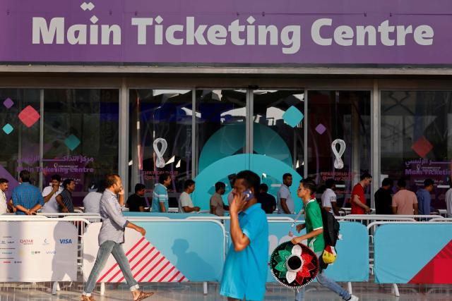 (FILES) Football fans line up outside the Main Ticketing Centre to try to get match tickets on November 18, 2022 in Doha, Qatar, ahead of the Qatar 2022 World Cup football tournament. The Football Supporters Europe (FSE) group filed a lawsuit on March 24, 2026, with the European Commission against football's world governing body FIFA over "excessive ticket prices" for this year's World Cup finals. (Photo by David GANNON / AFP)