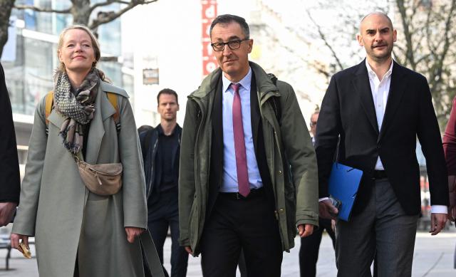 Cem Ozdemir (C) of the Greens party and winner of the state elections in Baden-Wuerttemberg, arrive with environment minister Thekla Walter,(L) and finance minister Danyal Bay the start of the exploratory talks with the Christian Democratic Party CDU following the state elections in Baden-Wuerttemberg in Stuttgart, southern Germany, on March 24, 2026. (Photo by THOMAS KIENZLE / AFP)
