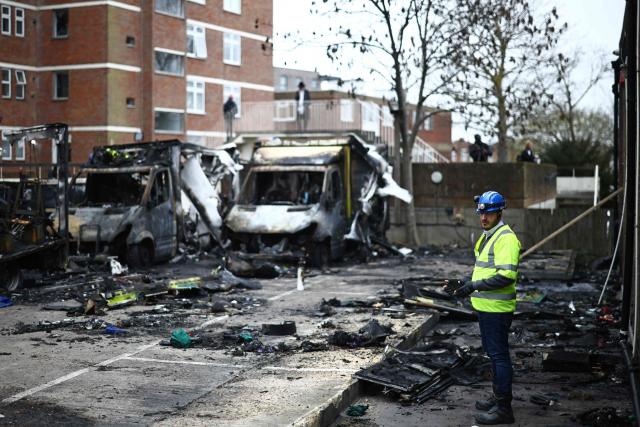 A workman studies the scene of an antisemitic arson attack in the Golders Green neighbourhood of north London, on March 24, 2026, an incident where volunteer ambulances run by a Jewish organisation were set on fire the previous night. Britain's Prime Minister Keir Starmer on March 23 condemned "a deeply shocking antisemitic arson attack" on volunteer ambulances run by a Jewish organisation in London. (Photo by Henry NICHOLLS / AFP)