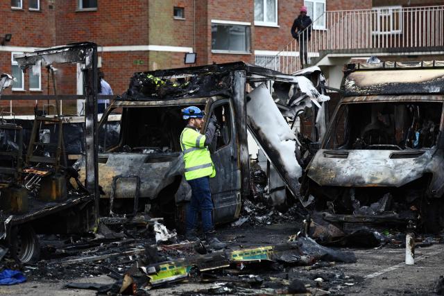 An official works among the burnt out ambulances at the scene of an antisemitic arson attack in the Golders Green neighbourhood of north London, on March 24, 2026, an incident where volunteer ambulances run by a Jewish organisation were set on fire the previous night. Britain's Prime Minister Keir Starmer on March 23 condemned "a deeply shocking antisemitic arson attack" on volunteer ambulances run by a Jewish organisation in London. (Photo by Henry Nicholls / AFP)
