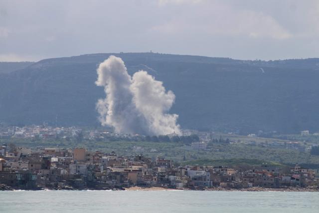 This photograph taken from the southern city of Tyre, shows smoke rising from the site of an Israeli airstrike that targeted the southern Lebanese village of Hanniyeh on March 24, 2026. Lebanon health ministry said an Israeli strike outside Beirut killed two people on March 24 after several strikes on the capital's southern suburbs overnight as the Israel-Hezbollah conflict entered its fourth week. (Photo by KAWANT HAJU / AFP)