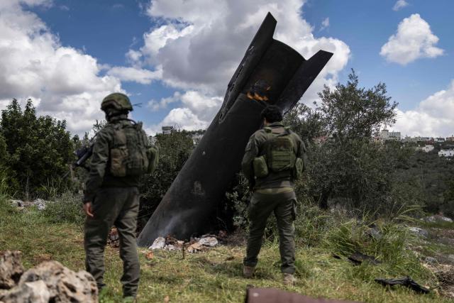 Israeli soldiers arrive to check an Iranian missile fragment that landed in the Israeli-occupied West Bank village of Hares on March 24, 2026. Since the United States and Israel unleashed strikes on Iran on February 28, war has spread across the Middle East, with casualties reported in countries across the region. (Photo by Ilia YEFIMOVICH / AFP)