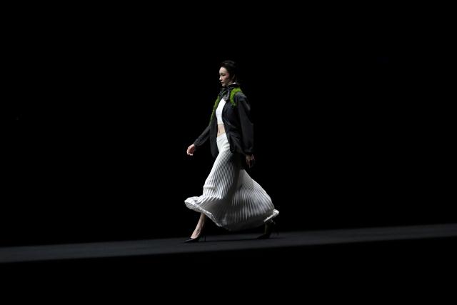A model displays a creation from the Shengze Silk Textile Fashion Show during the China Fashion week in Beijing on March 24, 2026. (Photo by WANG Zhao / AFP)