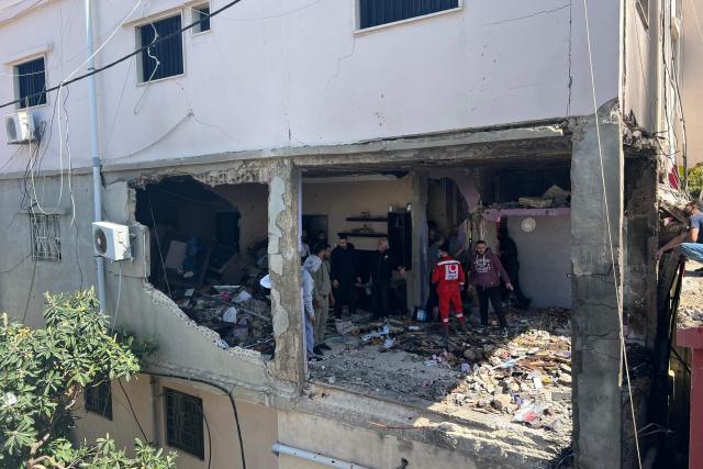 First aid responders inspect the site of an Israeli airstrike that taregted an apartment in the Palestinian refugee camp of Mieh Mieh near the southern Lebanese coastal city of Sidon on March 24, 2026. Lebanon was pulled into the Middle East war when Iran-backed Hezbollah began firing rockets into Israel on March 2 to avenge the killing of Iran's supreme leader Ayatollah Ali Khamenei. Israel has since launched strikes across Lebanon, killing at least 1,039 people and displacing more than a million others, and sent ground troops into the country's south. (Photo by Mahmoud ZAYYAT / AFP)
