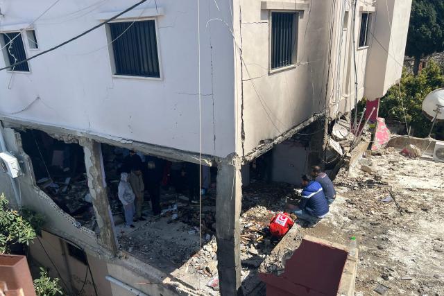 First aid responders inspect the site of an Israeli airstrike that taregted an apartment in the Palestinian refugee camp of Mieh Mieh near the southern Lebanese coastal city of Sidon on March 24, 2026. Lebanon was pulled into the Middle East war when Iran-backed Hezbollah began firing rockets into Israel on March 2 to avenge the killing of Iran's supreme leader Ayatollah Ali Khamenei. Israel has since launched strikes across Lebanon, killing at least 1,039 people and displacing more than a million others, and sent ground troops into the country's south. (Photo by Mahmoud ZAYYAT / AFP)
