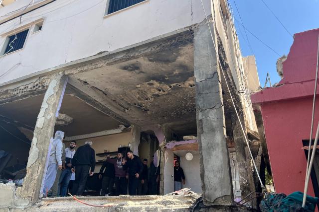First aid responders inspect the site of an Israeli airstrike that taregted an apartment in the Palestinian refugee camp of Mieh Mieh near the southern Lebanese coastal city of Sidon on March 24, 2026. Lebanon was pulled into the Middle East war when Iran-backed Hezbollah began firing rockets into Israel on March 2 to avenge the killing of Iran's supreme leader Ayatollah Ali Khamenei. Israel has since launched strikes across Lebanon, killing at least 1,039 people and displacing more than a million others, and sent ground troops into the country's south. (Photo by Mahmoud ZAYYAT / AFP)