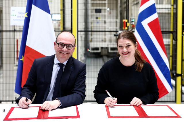 Norway's Industry minister Cecilie Myrseth (R) and France’s junior Minister for Industry Sebastien Martin (L) pose during the signing of the updated Franco-Norwegian green industrial partnership and the memorandum of understanding on critical metals, as part of a visit at the European vehicle battery venture Automotive Cells (ACC) site in Billy-Berclau, northern France, on March 24, 2026. (Photo by Sameer AL-DOUMY / AFP)