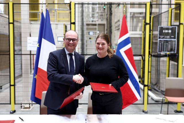 Norway's Industry minister Cecilie Myrseth (R) and France’s junior Minister for Industry Sebastien Martin (L) pose during the signing of the updated Franco-Norwegian green industrial partnership and the memorandum of understanding on critical metals, as part of a visit at the European vehicle battery venture Automotive Cells (ACC) site in Billy-Berclau, northern France, on March 24, 2026. (Photo by Sameer AL-DOUMY / AFP)