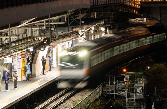 Commuters wait for the train at Ochanomizu station in Tokyo on March 24, 2026. (Photo by Andrew CABALLERO-REYNOLDS / AFP)