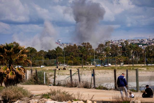 Smoke rises in the distance from the site of an Israeli airstrike that targeted the outskirts of the southern city of Tyre on March 24, 2026. Lebanon was pulled into the Middle East war when Iran-backed Hezbollah began firing rockets into Israel on March 2 to avenge the killing of Iran's supreme leader Ayatollah Ali Khamenei. Israel has since launched strikes across Lebanon, killing at least 1,039 people and displacing more than a million others, and sent ground troops into the country's south. (Photo by Dimitar DILKOFF / AFP)