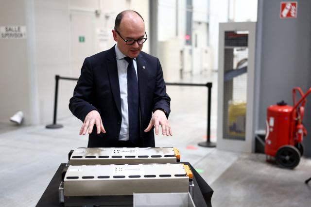 France’s junior Minister for Industry Sebastien Martin watches batteries during a visit at the European vehicle battery venture Automotive Cells (ACC) site in Billy-Berclau, northern France, on March 24, 2026. (Photo by Sameer AL-DOUMY / AFP)
