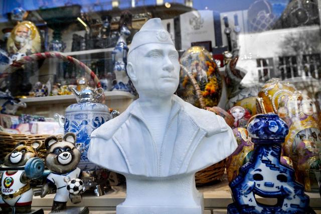 A marble bust of Russian President Vladimir Putin in a military uniform is seen in a display of a gift shop at the touristic Arbat street in downtown Moscow on March 24, 2026. (Photo by Alexander NEMENOV / AFP)