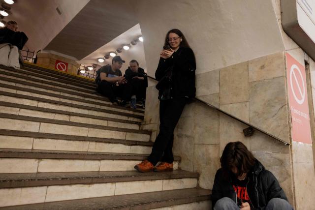 People take shelter at a metro station during an air strike alarm in Kyiv on March 24, 2026, amid Russia’s ongoing invasion of Ukraine. (Photo by Tetiana DZHAFAROVA / AFP)