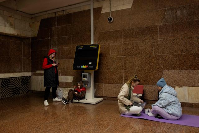 People take shelter at a metro station during an air strike alarm in Kyiv on March 24, 2026, amid the Russian invasion of Ukraine. (Photo by Tetiana DZHAFAROVA / AFP)