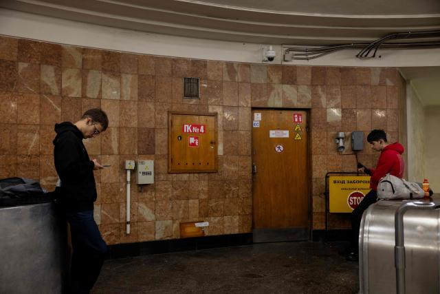 People take shelter at a metro station during an air strike alarm in Kyiv on March 24, 2026, amid the Russian invasion of Ukraine. (Photo by Tetiana DZHAFAROVA / AFP)