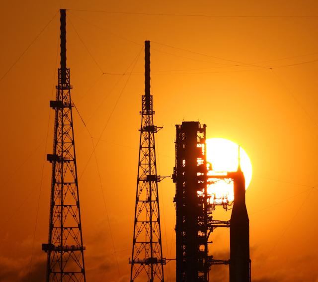 NASA's Artemis II Space Launch System (SLS) rocket and Orion spacecraft are seen at sunrise at Launch Pad 39B at the Kennedy Space Center in Cape Canaveral, Florida on March 24, 2026. NASA on March 19 began returning its towering SLS rocket and Orion spacecraft to its Florida launch pad ahead of a planned flyby of the Moon, after completing necessary repairs. The next launch window opens on April 1. (Photo by Gregg Newton / AFP)