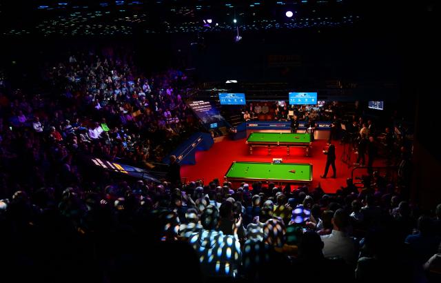 (FILES) A view of the Crucible before the table divider comes down ahead of play in the World Championship Snooker second round matches at The Crucible in Sheffield, England on April 25, 2022. Snooker’s World Championship will remain at the Crucible in Sheffield following a landmark long term agreement between World Snooker Tour and Sheffield City Council. (Photo by Paul ELLIS / AFP)