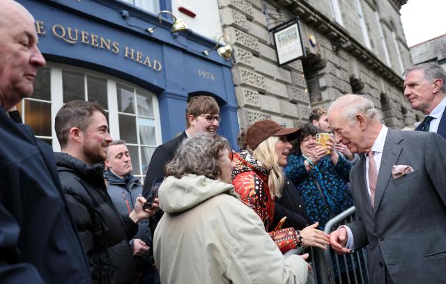 Britain's King Charles III meets members of the public outside the Queens Head pub during a visit to St Austell, south-west England on March 24, 2026. (Photo by Adrian DENNIS / POOL / AFP)