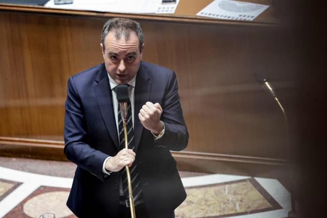 This photograph taken through a window shows France's Prime Minister Sebastien Lecornu speaking during a session of questions to the government at The National Assembly, France's lower house of parliament in Paris on March 24, 2026. (Photo by STEPHANE DE SAKUTIN / AFP)