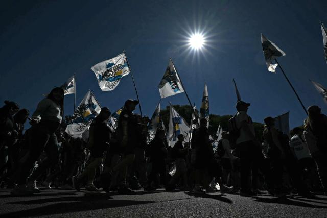 People take part in a march to Plaza de Mayo aquare in Buenos Aires on March 24, 2026, on the 50th anniversary of the beginning of the last military dictatorship. In Argentina, March 24th is a day of mourning, marches and political disputes. Fifty years on from the coup d’etat, thousands of people are taking to the streets again to commemorate the victims of a dictatorship that the government of far-right leader Javier Milei is seeking to rewrite. (Photo by Luis ROBAYO / AFP)