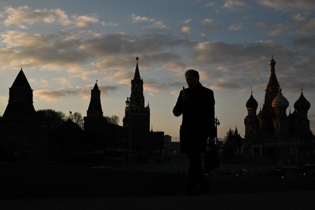 A man walks on Moskvoretsky bridge with a view of the Kremlin in the background, in central Moscow on March 24, 2026. (Photo by Igor IVANKO / AFP)