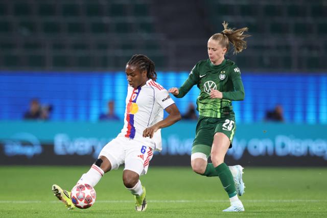 Lyon's Haitian midfielder #06 Melchie Dumornay and VfL Wolfsburg's German forward #25 Vivien Endemann vie for the ball during the UEFA Women's Champions League Quarter final First Leg football match VfL Wolfsburg v Olympique Lyonnais (OL) in Wolfsburg, northern Germany, on March 24, 2026. (Photo by Ronny HARTMANN / AFP)