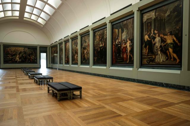 This photograph shows a general view of The Medicis Gallery, in which are displayed 24 paintings by Flemish artist Peter Paul Rubens constituting the 'Marie de Medici Cycle', before their restoration, at Musee du Louvre in Paris on March 24, 2026. The Louvre has unveiled the details of an “exceptional operation” to restore the 24 paintings of the “Marie de’ Medici Cycle,” painted in the early 17th century by Rubens, one of the masters of Flemish painting. A call for tenders is underway to find two teams of restorers who will work simultaneously, starting in the autumn, on a project expected to last four years. (Photo by Blanca CRUZ / AFP)