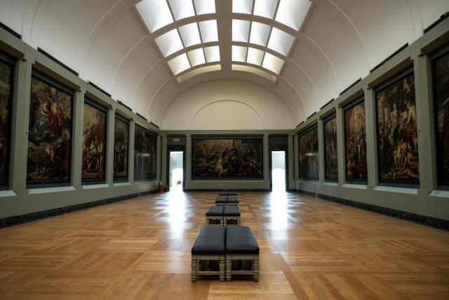 This photograph shows a general view of The Medicis Gallery, in which are displayed 24 paintings by Flemish artist Peter Paul Rubens constituting the 'Marie de Medici Cycle', before their restoration, at Musee du Louvre in Paris on March 24, 2026. The Louvre has unveiled the details of an “exceptional operation” to restore the 24 paintings of the “Marie de’ Medici Cycle,” painted in the early 17th century by Rubens, one of the masters of Flemish painting. A call for tenders is underway to find two teams of restorers who will work simultaneously, starting in the autumn, on a project expected to last four years. (Photo by Blanca CRUZ / AFP)