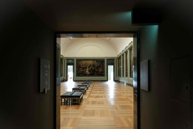 This photograph shows a view of "L'Apotheose de Henri IV et la proclamation de la regence de la reine" (1622-1625) by by Flemish artist Peter Paul Rubens in The Medicis Gallery, in which are displayed 24 paintings by Rubens constituting the 'Marie de Medici Cycle', before their restoration, at Musee du Louvre in Paris on March 24, 2026. The Louvre has unveiled the details of an “exceptional operation” to restore the 24 paintings of the “Marie de’ Medici Cycle,” painted in the early 17th century by Rubens, one of the masters of Flemish painting. A call for tenders is underway to find two teams of restorers who will work simultaneously, starting in the autumn, on a project expected to last four years. (Photo by Blanca CRUZ / AFP)