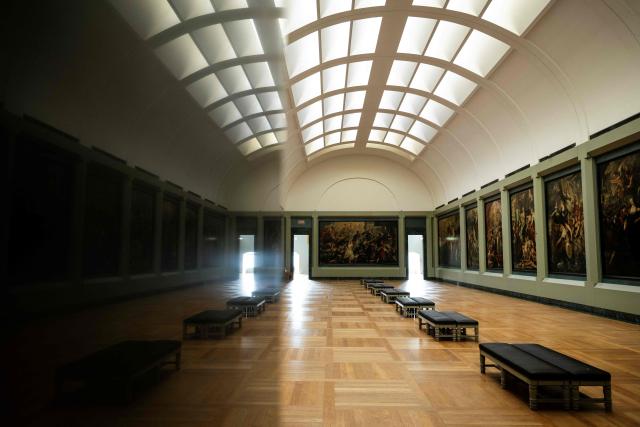 This photograph shows a general view of The Medicis Gallery, in which are displayed 24 paintings by Flemish artist Peter Paul Rubens constituting the 'Marie de Medici Cycle', before their restoration, at Musee du Louvre in Paris on March 24, 2026. The Louvre has unveiled the details of an “exceptional operation” to restore the 24 paintings of the “Marie de’ Medici Cycle,” painted in the early 17th century by Rubens, one of the masters of Flemish painting. A call for tenders is underway to find two teams of restorers who will work simultaneously, starting in the autumn, on a project expected to last four years. (Photo by Blanca CRUZ / AFP)